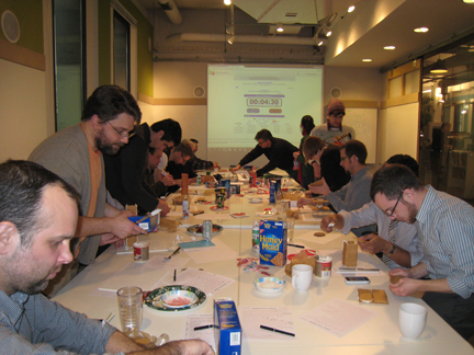 Daedalus employees creating gingerbread houses during the holiday party. 