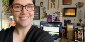 Daedalus UX Designer Jenn Scott taking a selfie at her desk at home