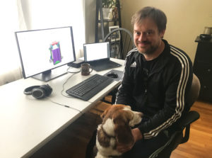 Daedalus Mechanical Engineer John Puskar-Pasewicz in his home office with his dog. 
