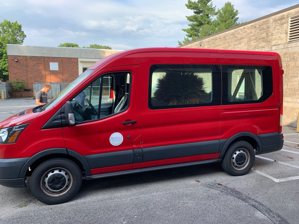 Red Berea College van sits in the Daedalus parking lot.
