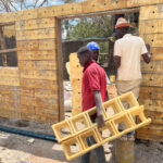 Workers in Kenya build a school using ICF Blocks